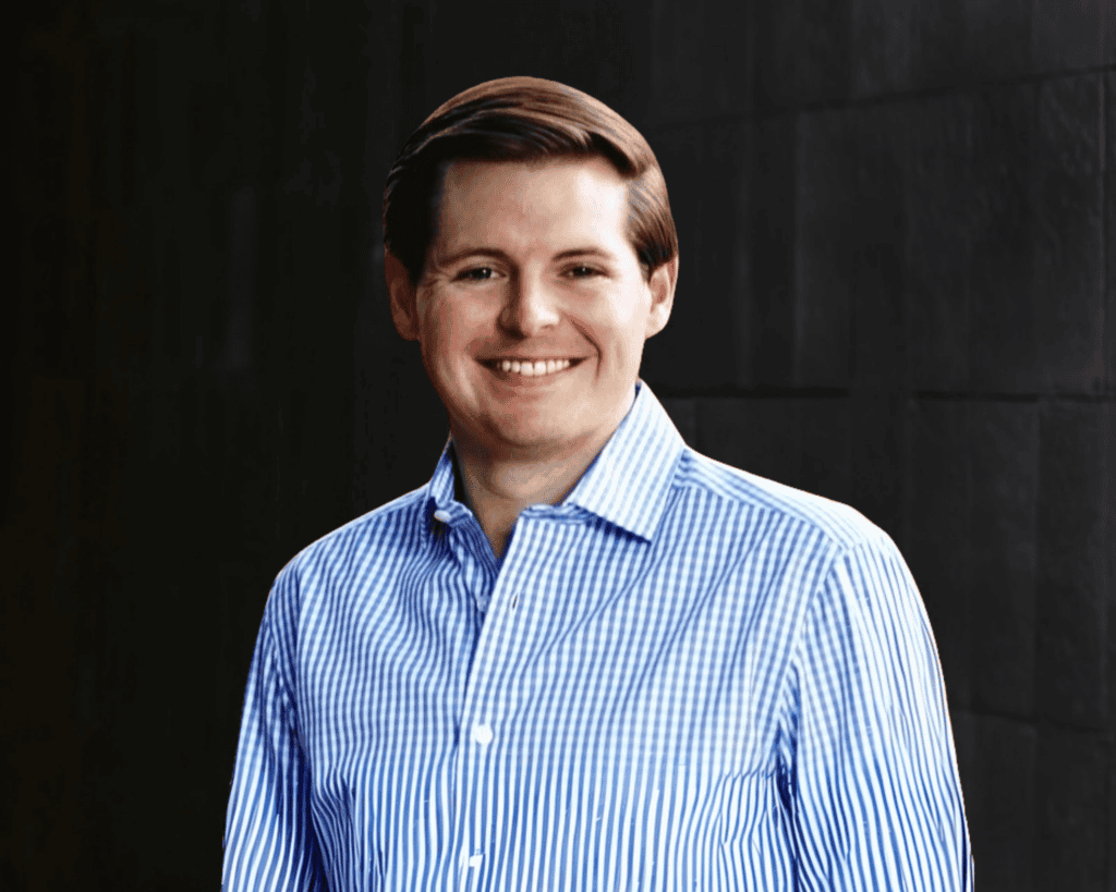 Professional headshot style photo of Jacob Squires against a black background.