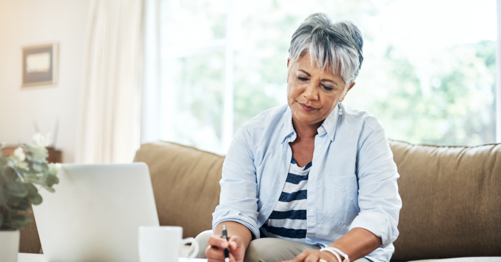 Retirement Income Planning: Building a Plan That Can Last 30 Years Webinar Thumbnail - Retired woman writing down notes on notepad with laptop beside her.